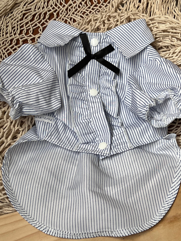 CAMISA DE RAYITAS AZUL MARINO FONDO BLANCO, CON BOTONES A PRESION Y OLANES EN LA PARTE DE ENFRENTE QUE PARECE LAS CAMISAS DE ESMOQUIN. PARA PERRITO O GATITO DE RAZA PEQUEÑA.