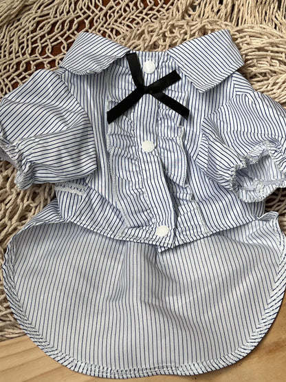 CAMISA DE RAYITAS AZUL MARINO FONDO BLANCO, CON BOTONES A PRESION Y OLANES EN LA PARTE DE ENFRENTE QUE PARECE LAS CAMISAS DE ESMOQUIN. PARA PERRITO O GATITO DE RAZA PEQUEÑA.